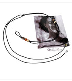 Close up of hand knotted black wax cord featuring colorful resin beads and thin adjustable tie