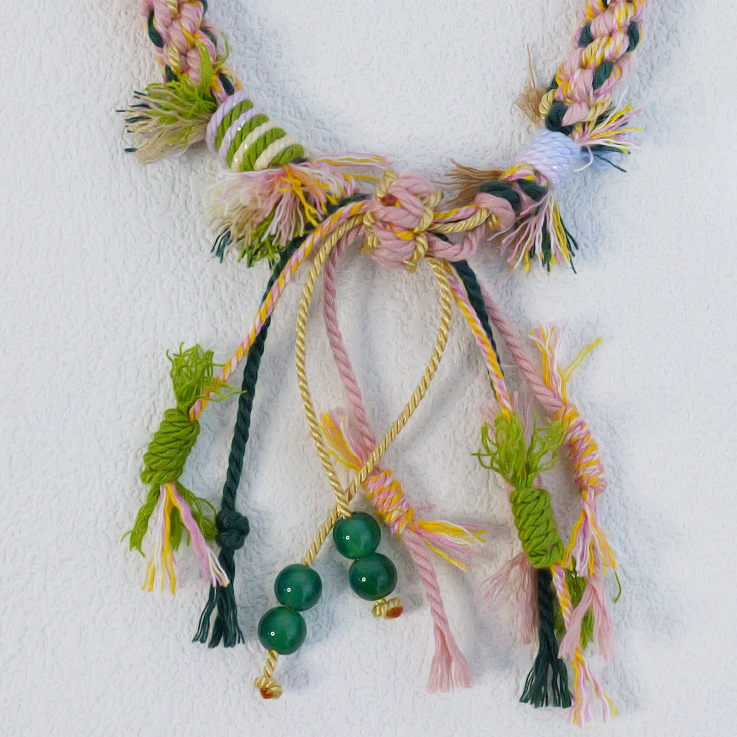 Close up of hand-woven multi-color ethnic knot friendship bracelet