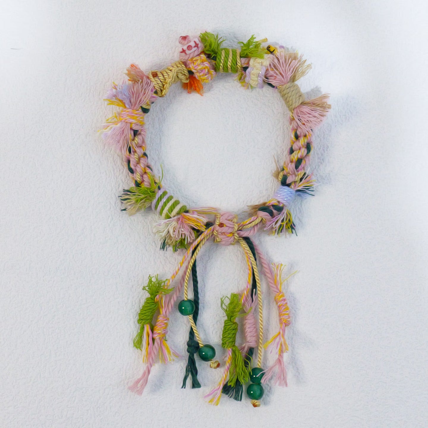 Handmade colorful Tibetan style braided bracelet with tassels and green beads