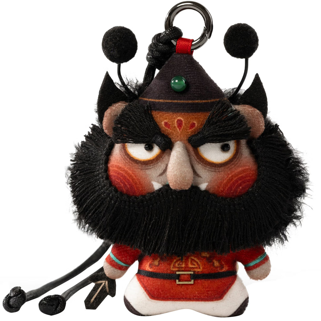 Close up of hand embroidered Zhong Kui face and reward good punish evil tag on herbal sachet charm