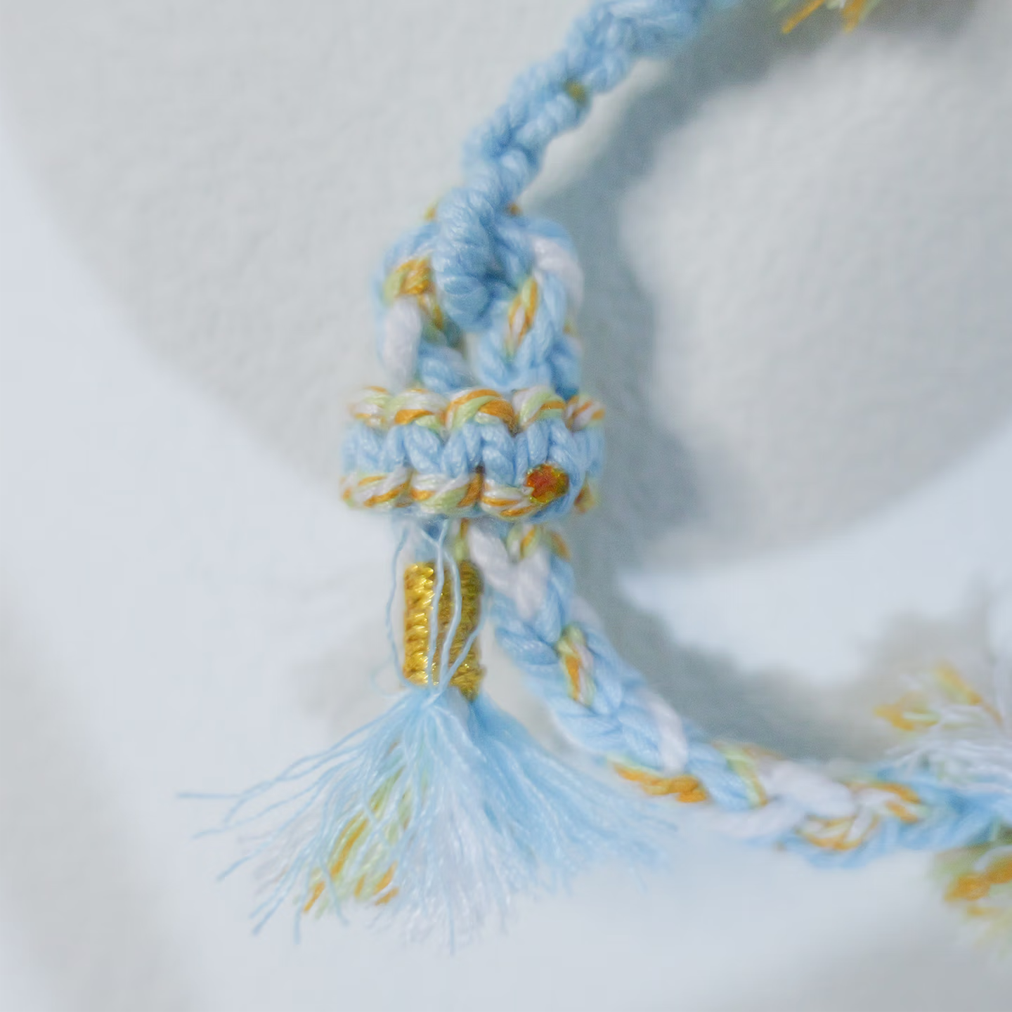 Floral inspiration graphic showing blue hydrangeas and handmade sky blue woven bracelet
