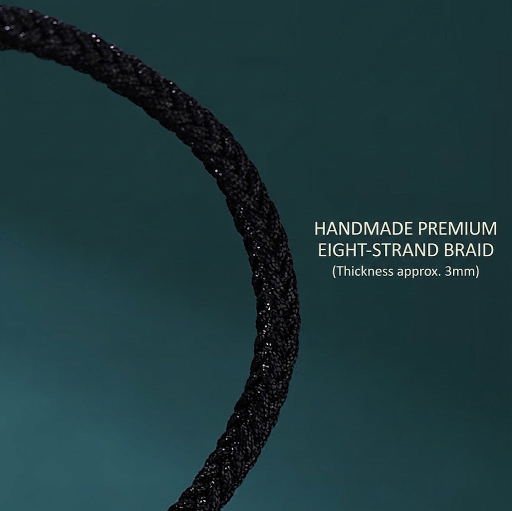 S999 fine silver Six-Syllable Mantra rotating bead on black hand-woven cord with gold accents