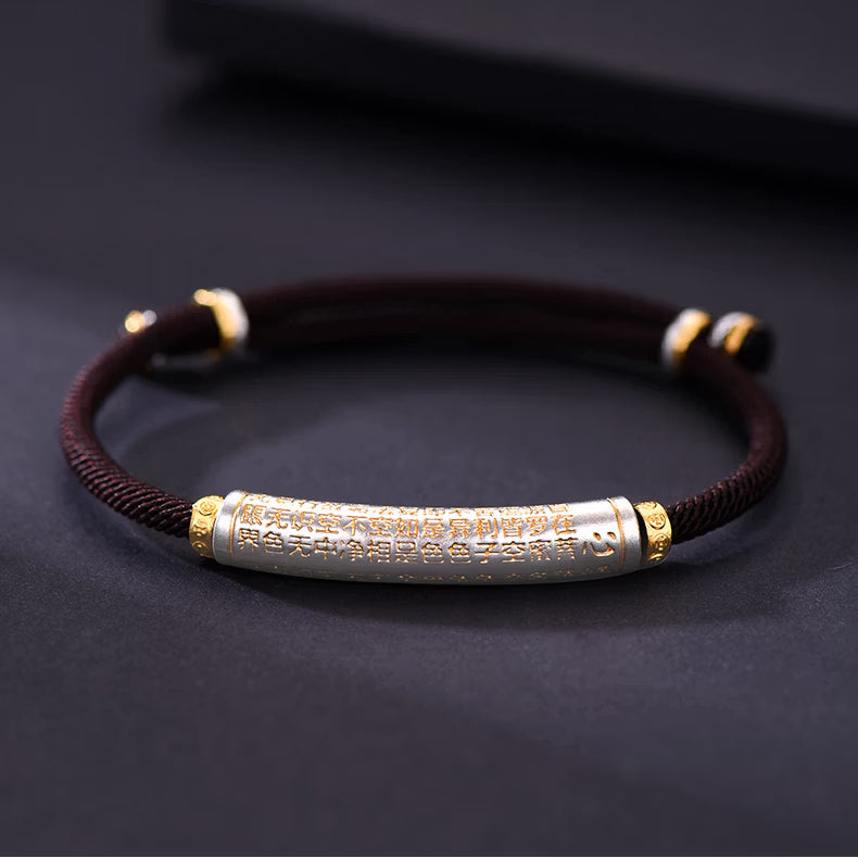 English: S999 fine silver Heart Sutra curved tube bracelet with gold gilded calligraphy on dark braided cord