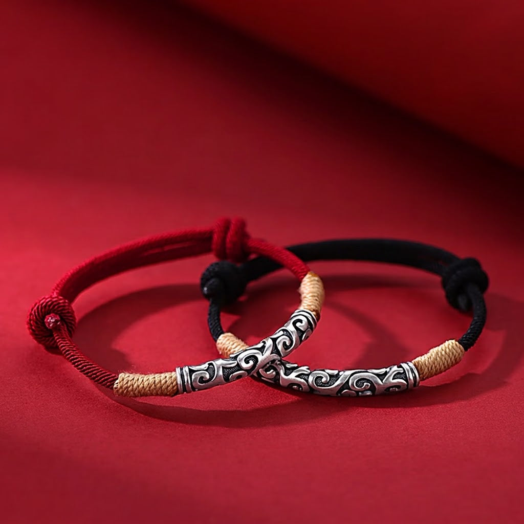 Pair of S999 fine silver auspicious cloud hand-cast tube bracelets on red and black hand-woven cords