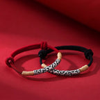 Pair of S999 fine silver auspicious cloud hand-cast tube bracelets on red and black hand-woven cords