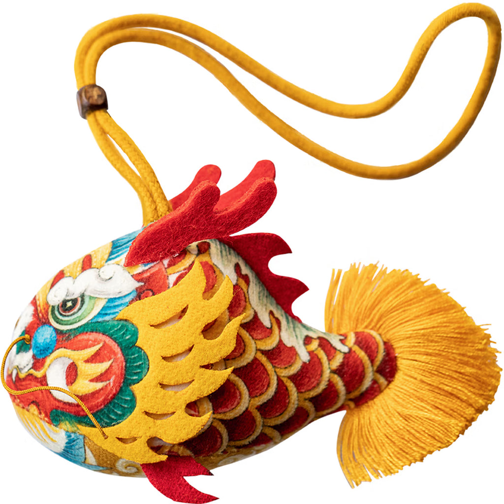 Smiling girl holding a handmade cute silk dragon carp sachet pendant with red blessing tag