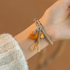 Close up of hand-knotted ethnic cord weave and polished yellow amber pendant charm