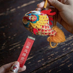 Smiling girl holding a handmade cute silk dragon carp sachet pendant with red blessing tag