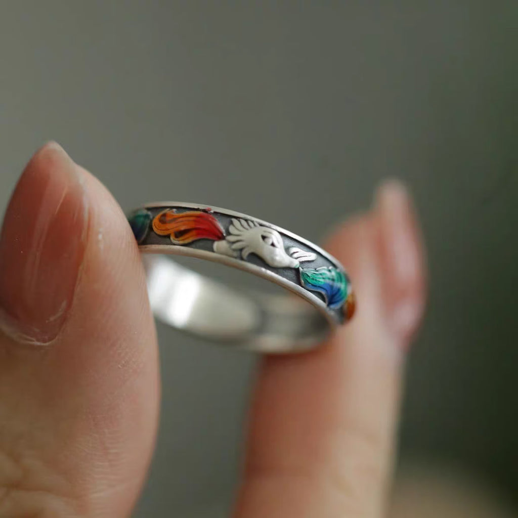 Close up of surface applied multicolor enamel fox tail details on vintage sterling silver ring band