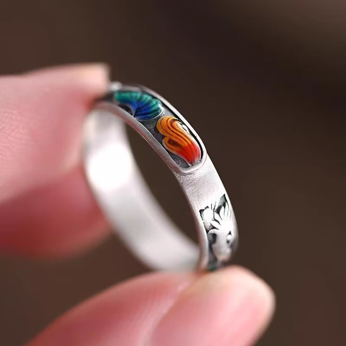 Close up of surface applied multicolor enamel fox tail details on vintage sterling silver ring band