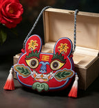 Collection of handcrafted Longxi embroidery tiger head crossbody bags in off-white and blue with long tassels