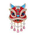 Close up of red enamel and faux rhinestone details on oriental lion dance suit lapel pin