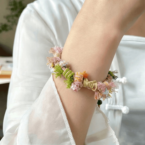Handmade colorful Tibetan style braided bracelet with tassels and green beads