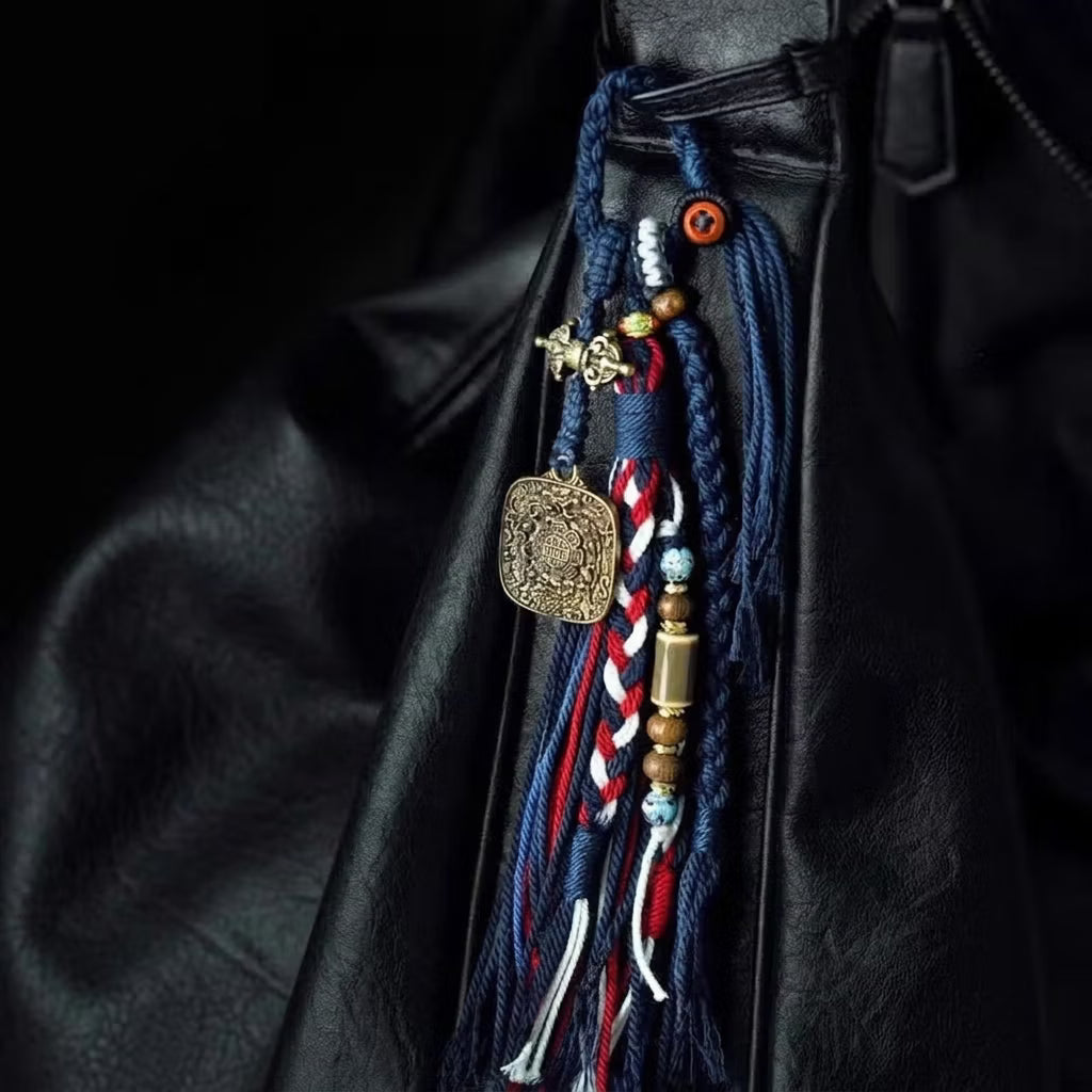 Handcrafted Tibetan braided blue and red tassel ornament with antique brass Vajra charm for bag or car hanging