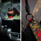Close up of hand embroidered Zhong Kui face and reward good punish evil tag on herbal sachet charm