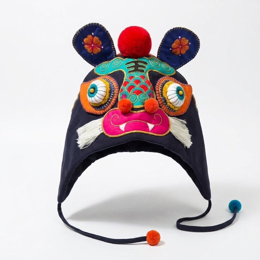 Handcrafted Chinese embroidered tiger head hat in dark navy with colorful 3D eyes and pom-poms