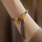 Handmade Tibetan 5-color braided cord bracelet with golden prayer wheel charm and leaves